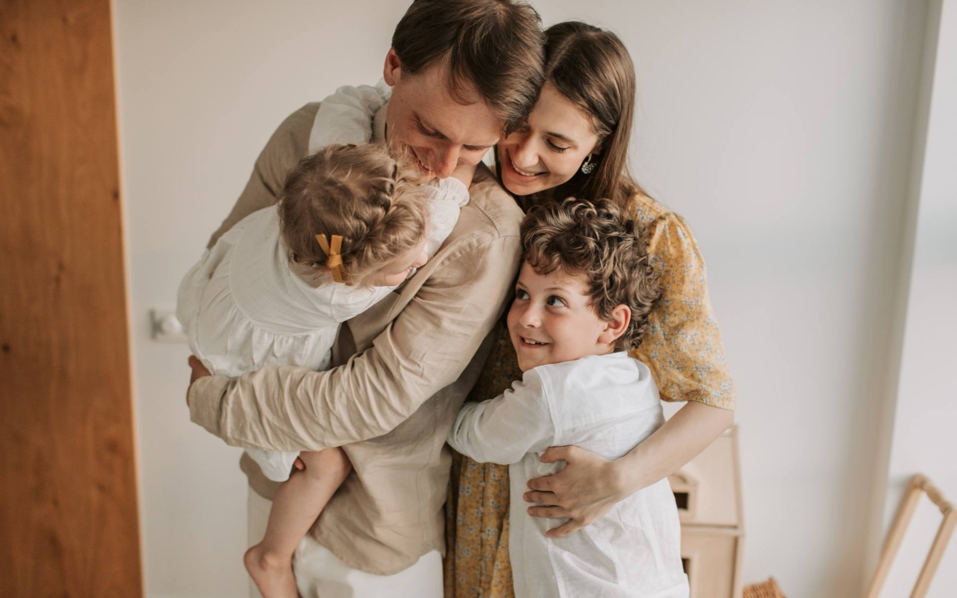 Family of four in a group hug