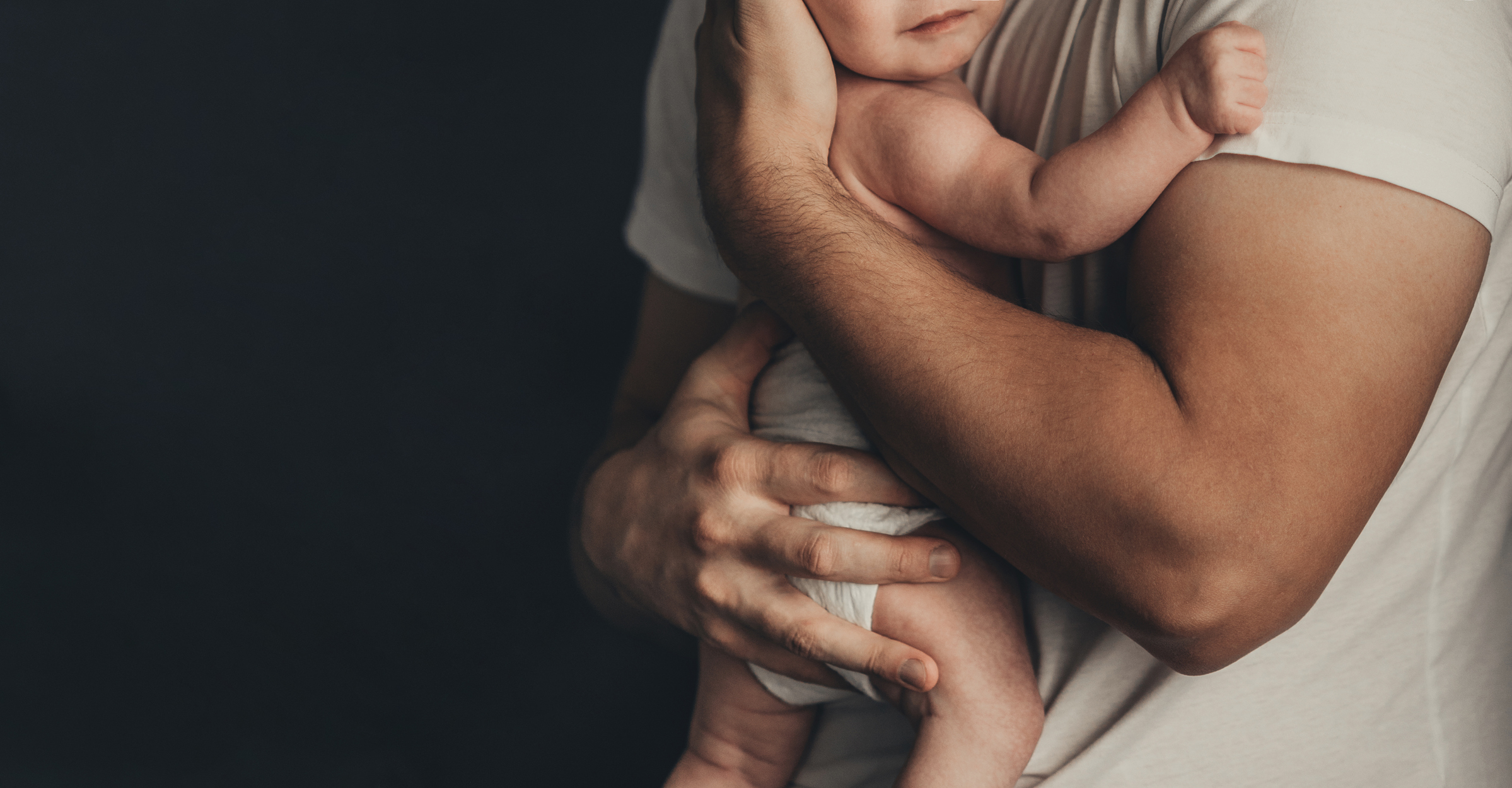 Parent holding a newborn — pediatric genetic testing for families