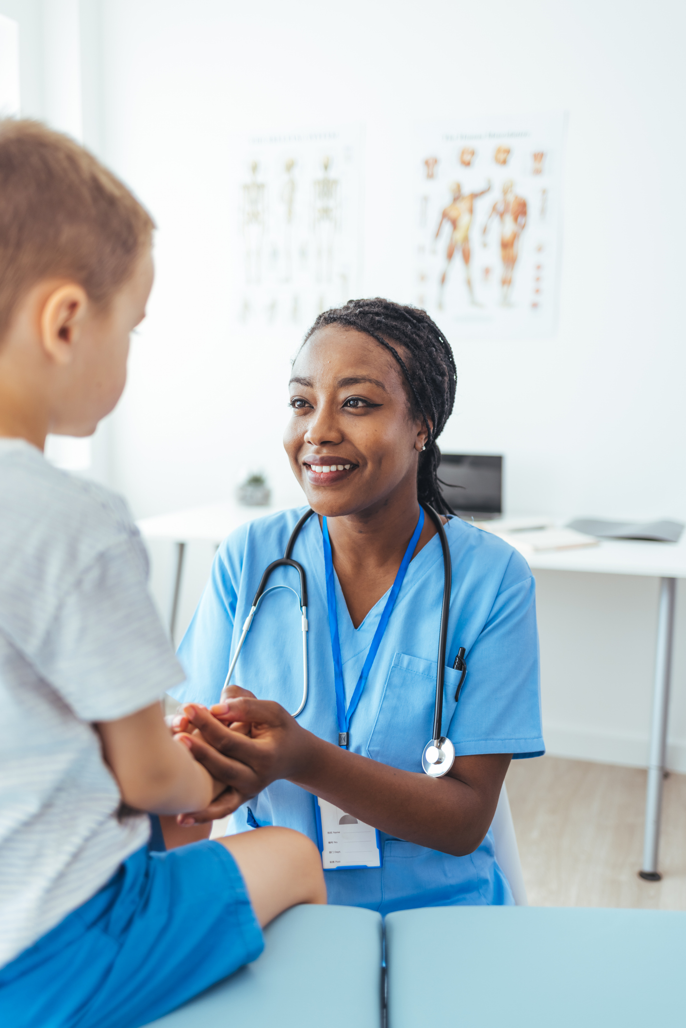 A pediatrician with a young patient and family
