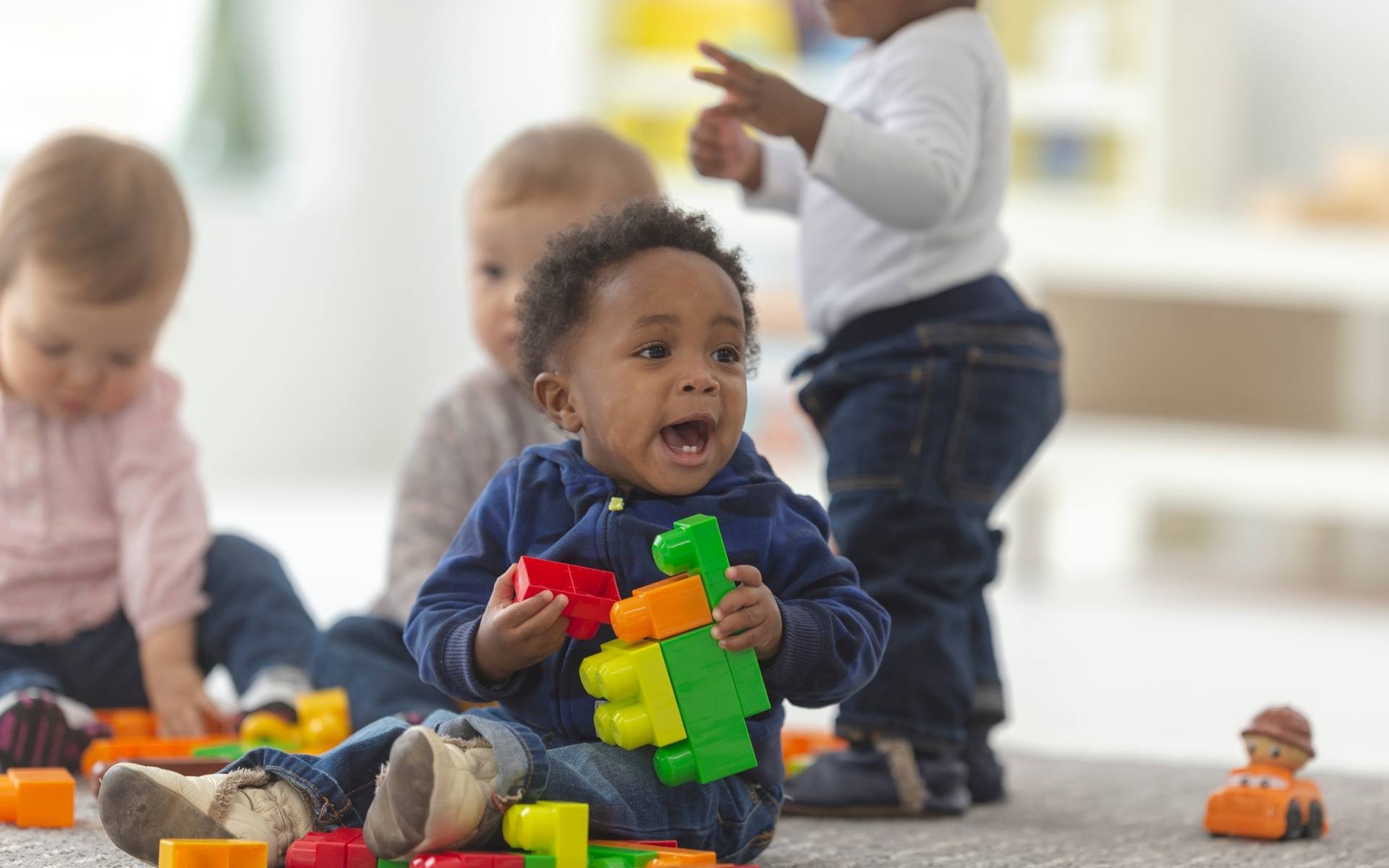 Tot playing with toy - some delays have genetic causes