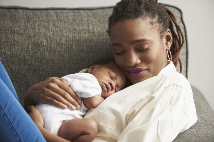 A mother snuggling with her child